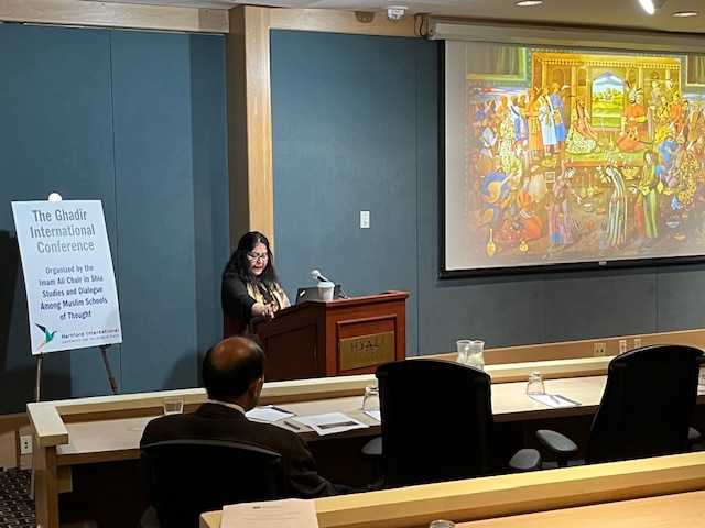 Woman at podium with slide in background