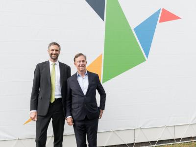 President Joel Lohr standing with Gov. Ned Lamont in front of ascending dove logo