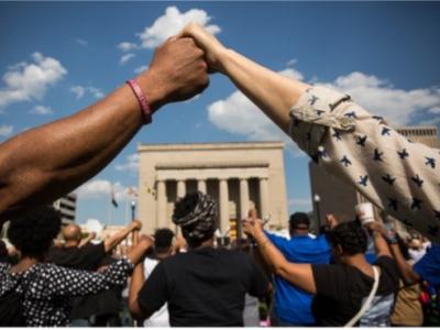 Black hand holding white hand