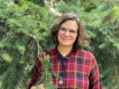 Woman standing near a pine tree